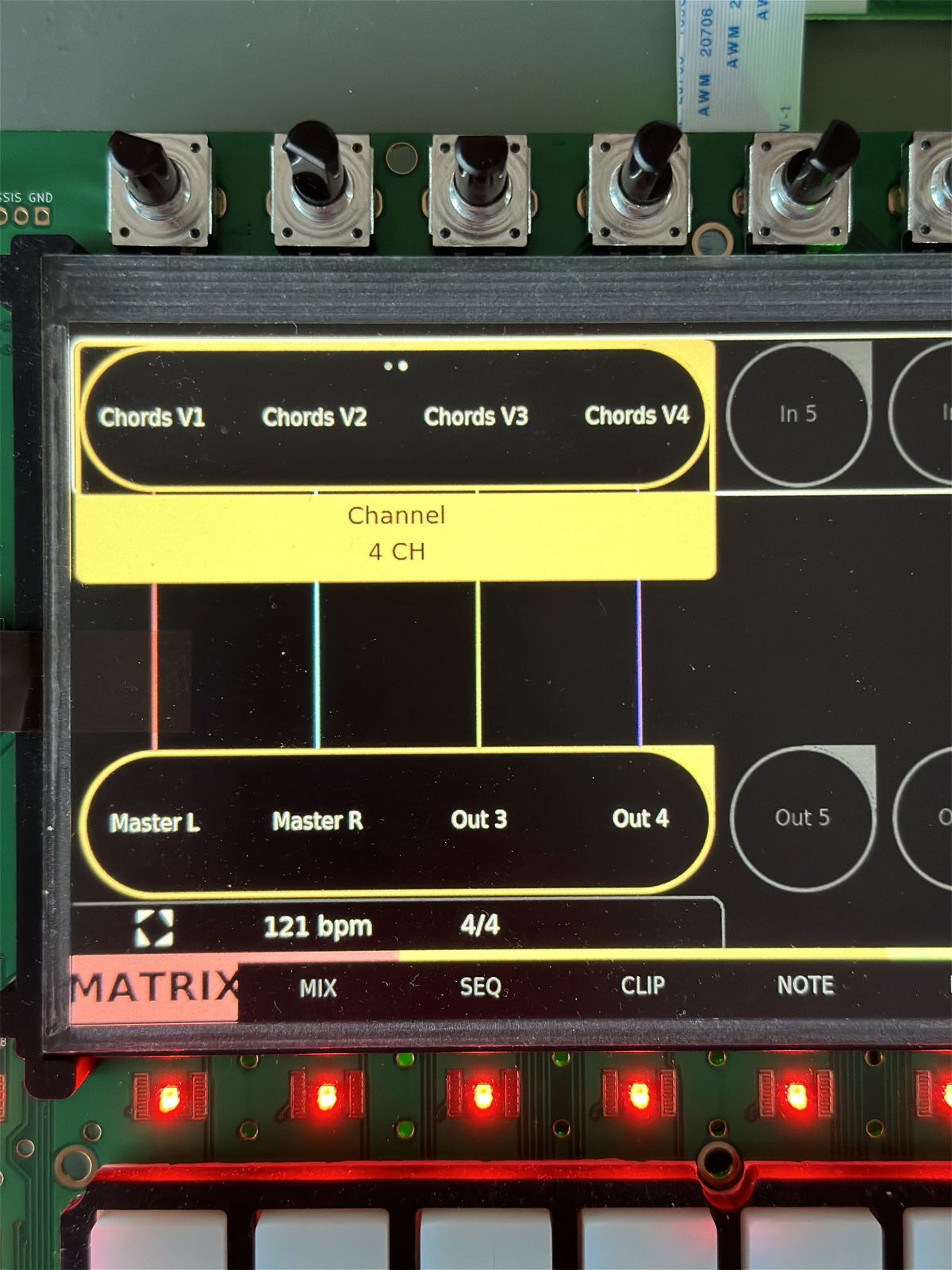 Close-up of encoders above the screen, with channel names shown directly under them