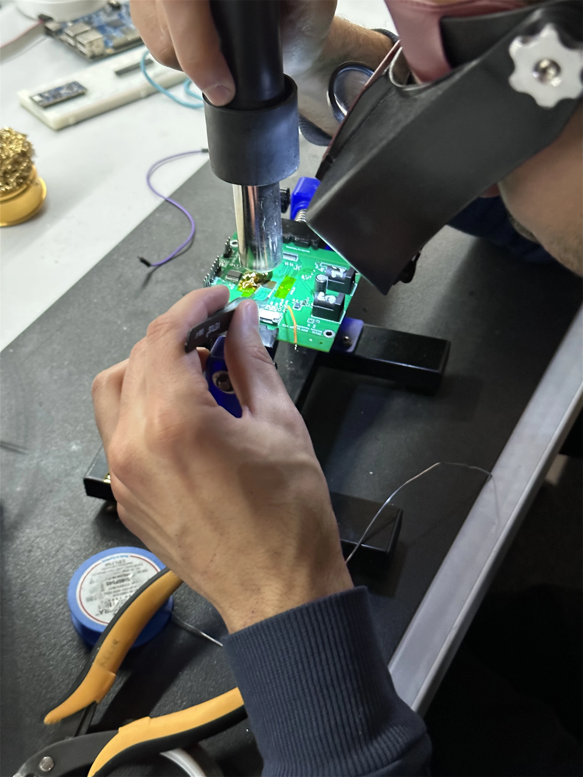 Reworking a display board with a hot-air station under a magnifier